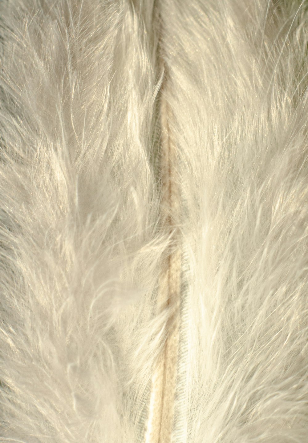white fur textile on brown textile