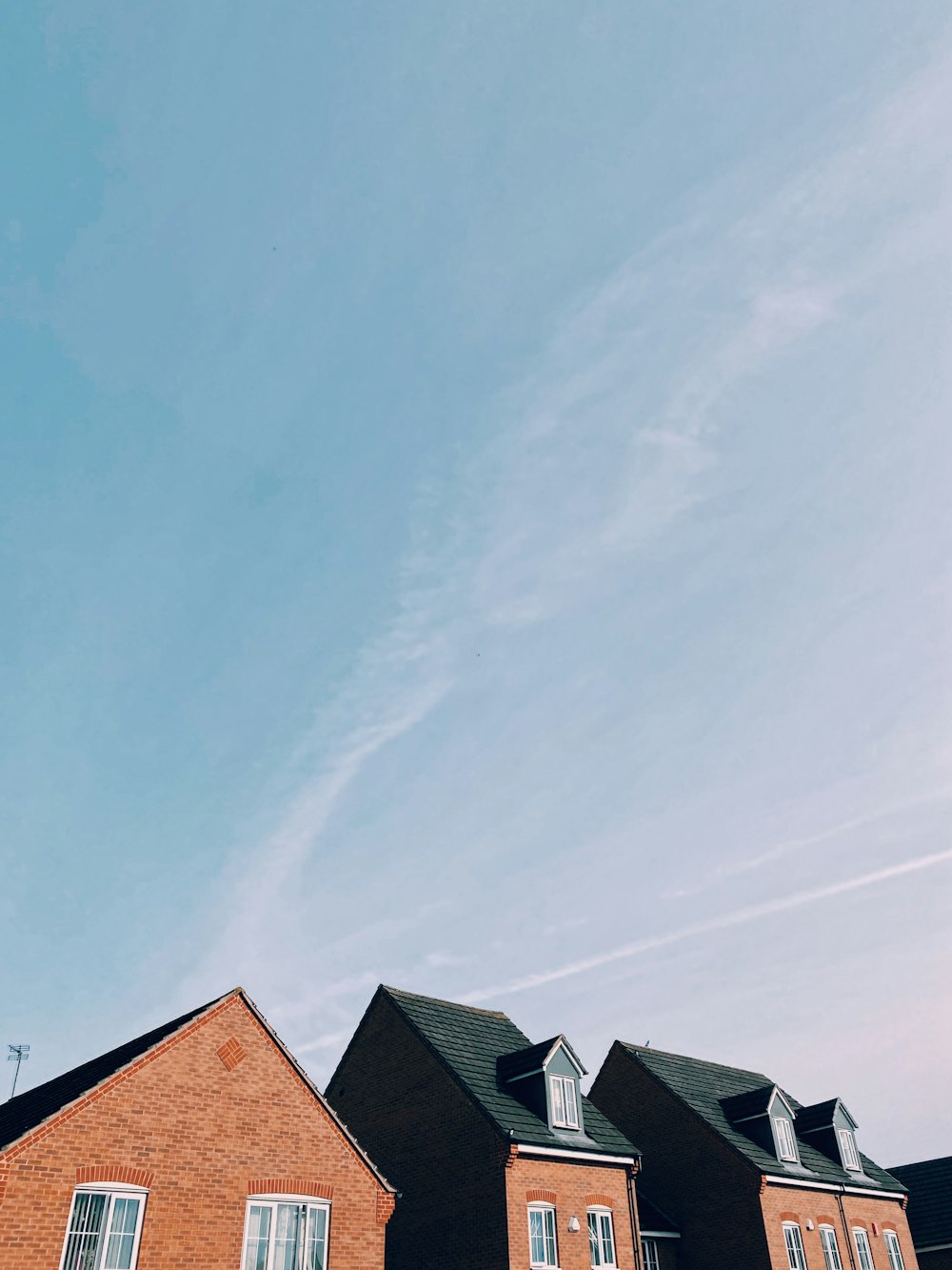 brown and black concrete house under blue sky during daytime