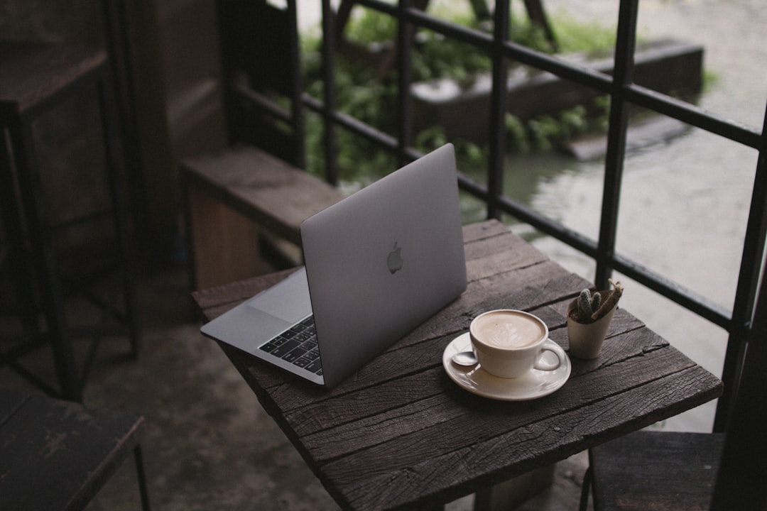 macbook air on brown wooden table, work and Lancaster latte coffee