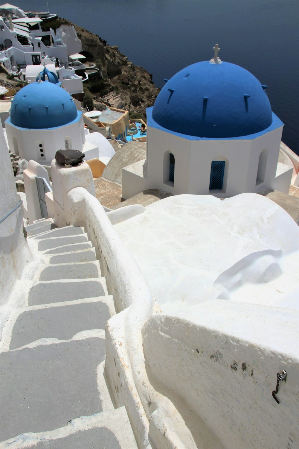 a white and blue building next to a body of water