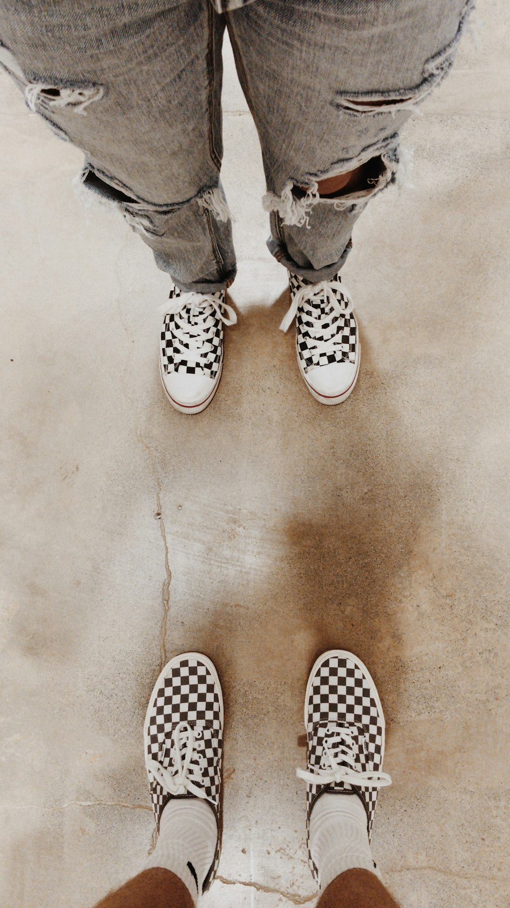 person wearing white and black polka dot sneakers