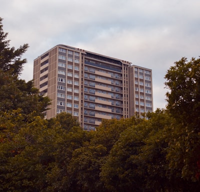 green trees near white concrete building during daytime