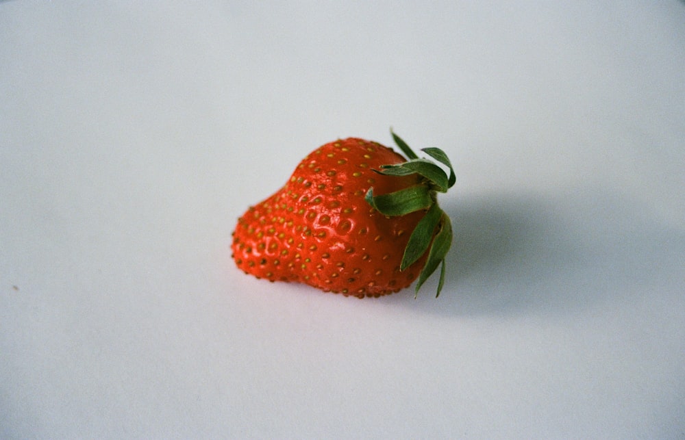 strawberry fruit on white surface