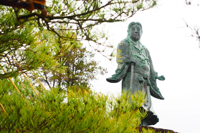 A stone statue among trees