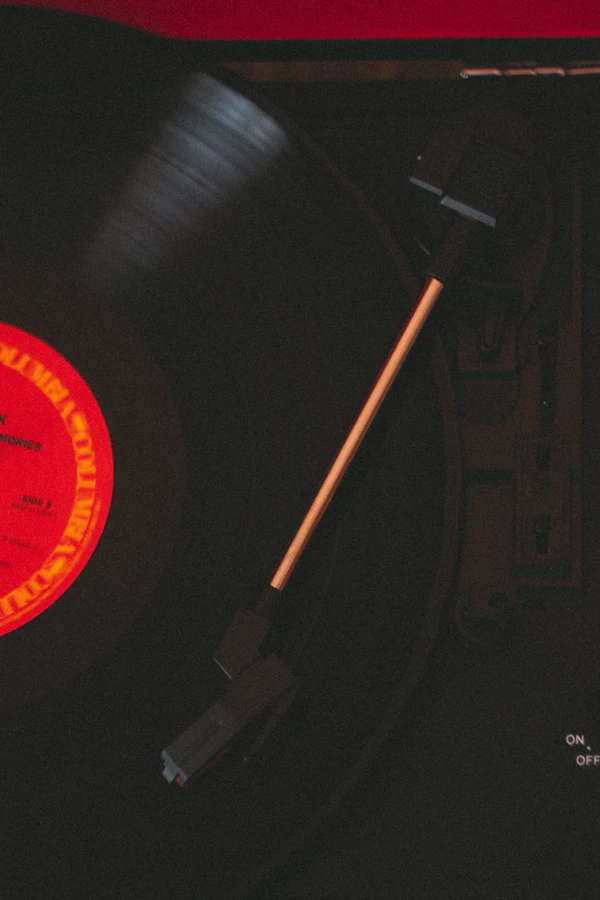 A black-and-white vinyl record on a turntable in low light