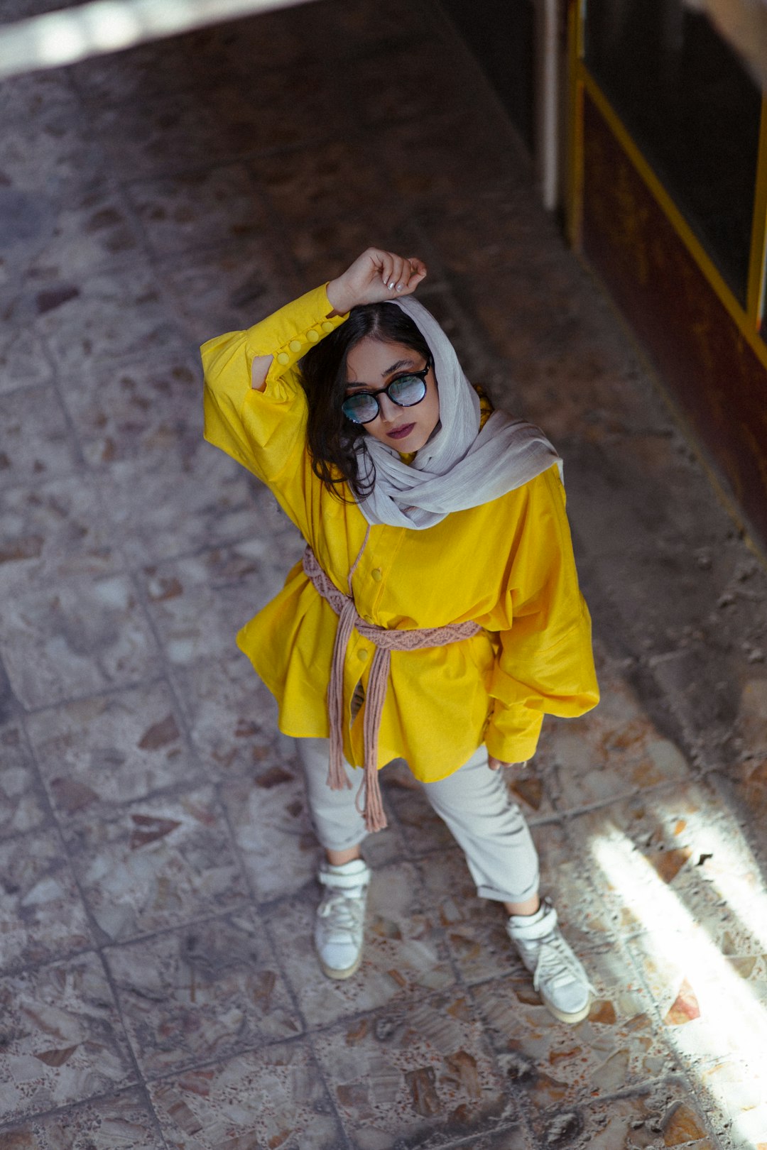 girl in yellow hoodie wearing black framed eyeglasses