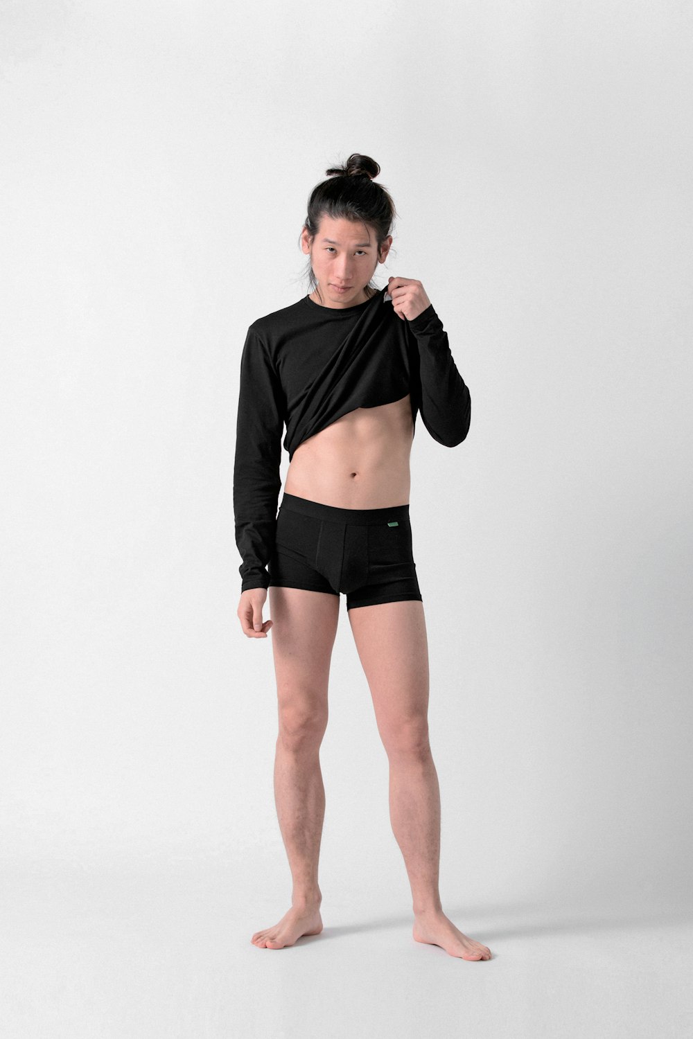 woman in black long sleeve crop top and black shorts