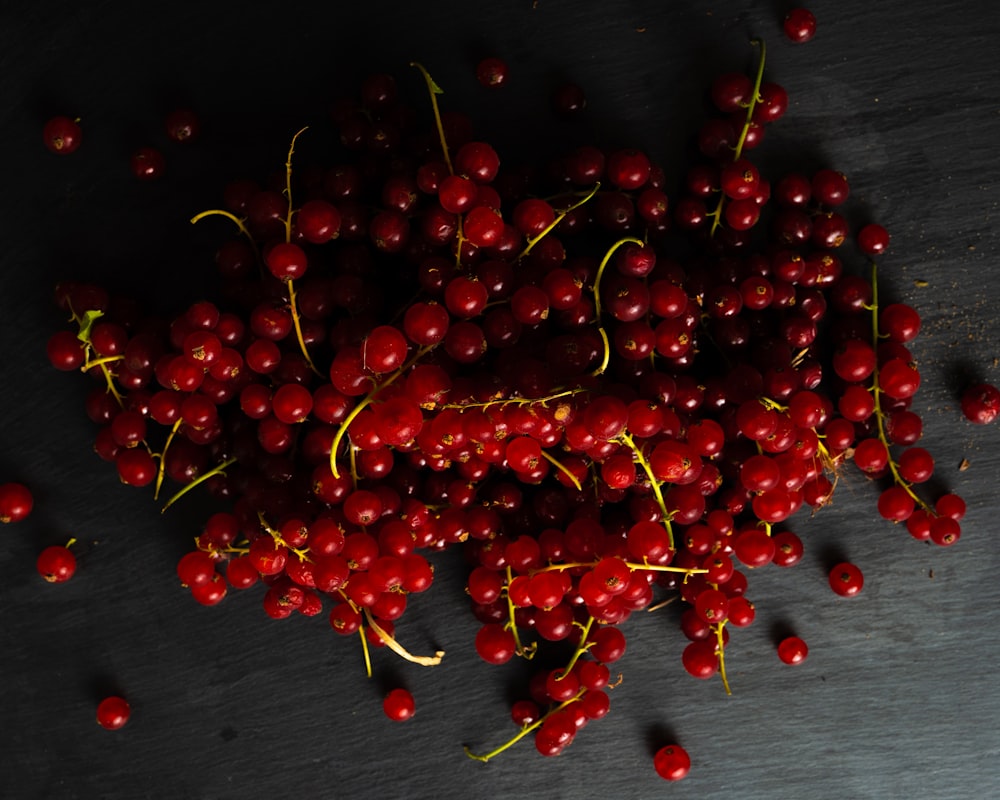 red cherries on black wooden table