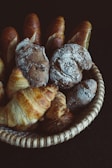 Close-up of freshly baked golden baguettes stacked in a rustic basket.