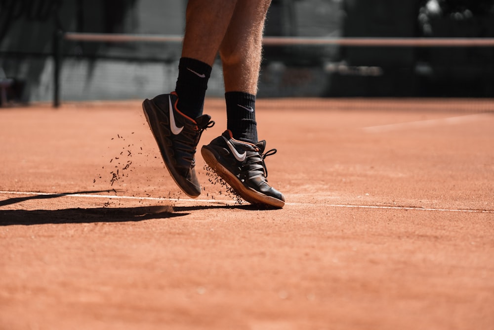 person in black nike running shoes