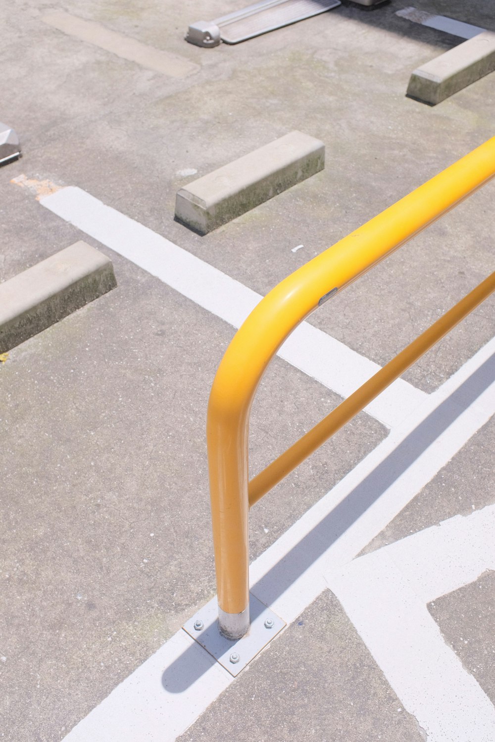 orange metal railings on gray concrete pavement