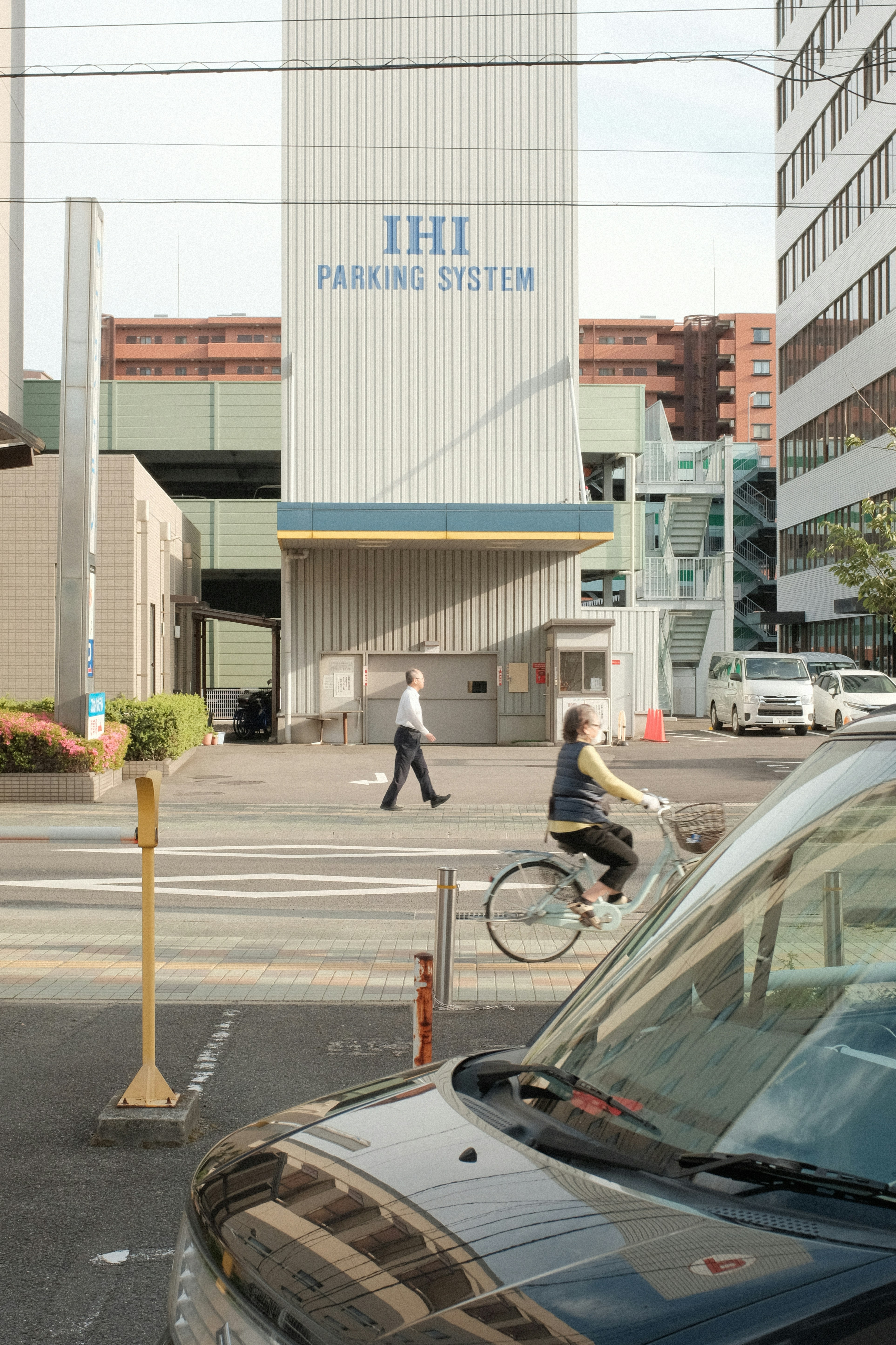 man in black jacket and pants walking on pedestrian lane during daytime