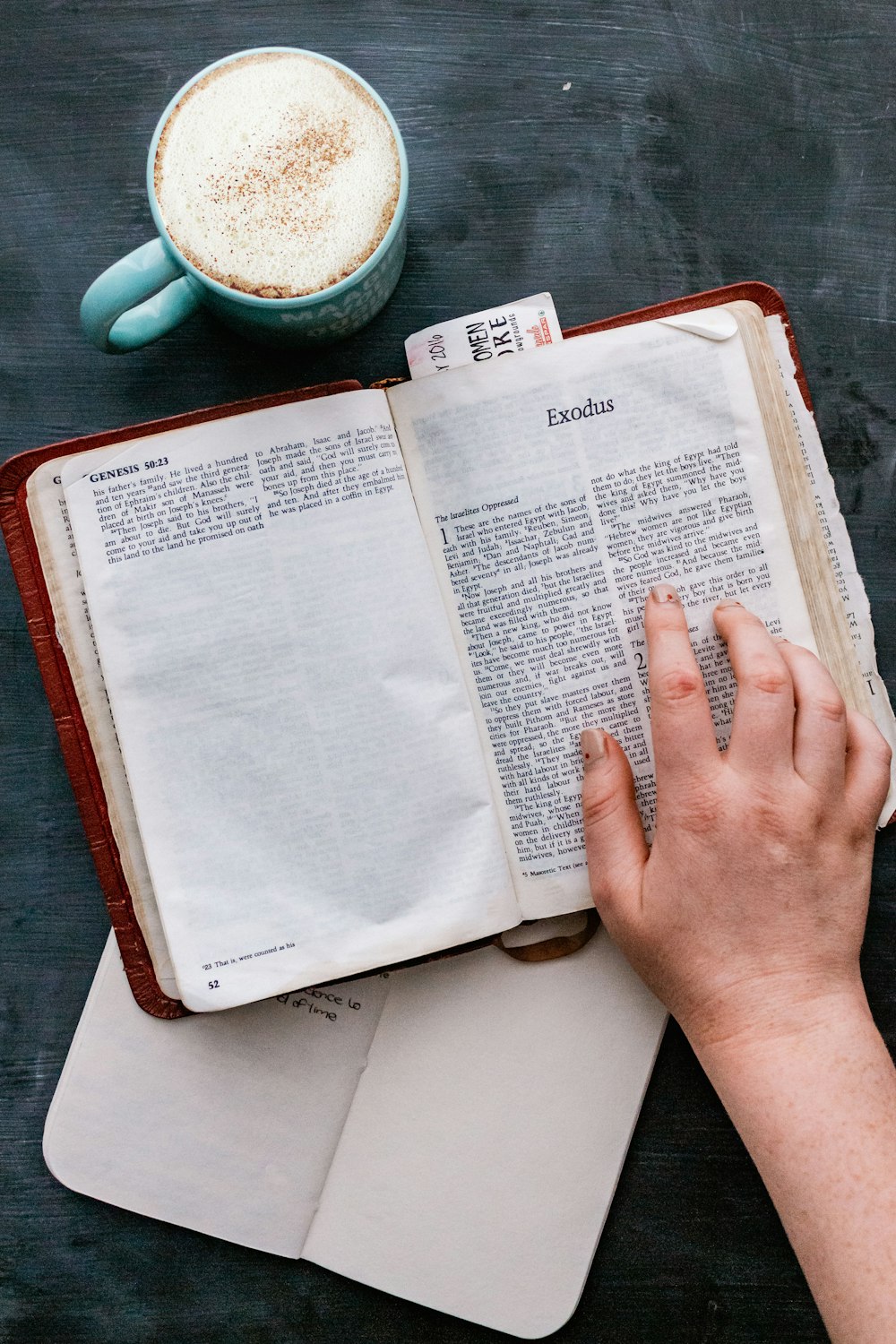 person holding white book page