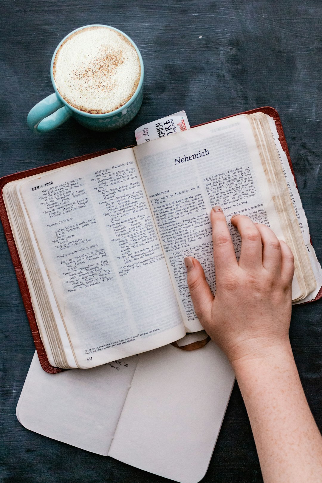 person holding white book page