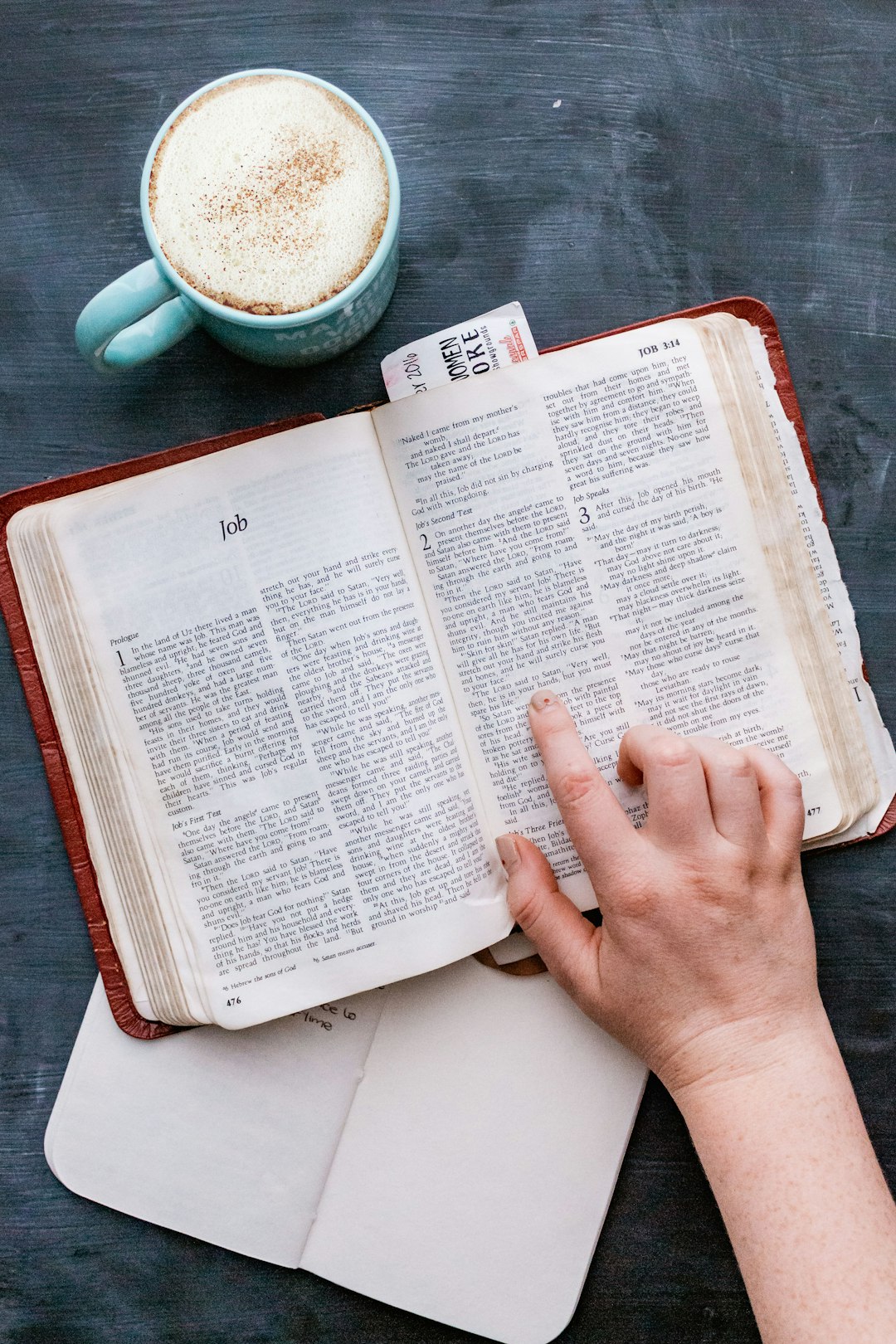 person holding white book page