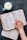 An open book with a cup of tea beside it on a wooden table.