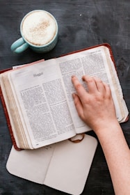 person holding white book page