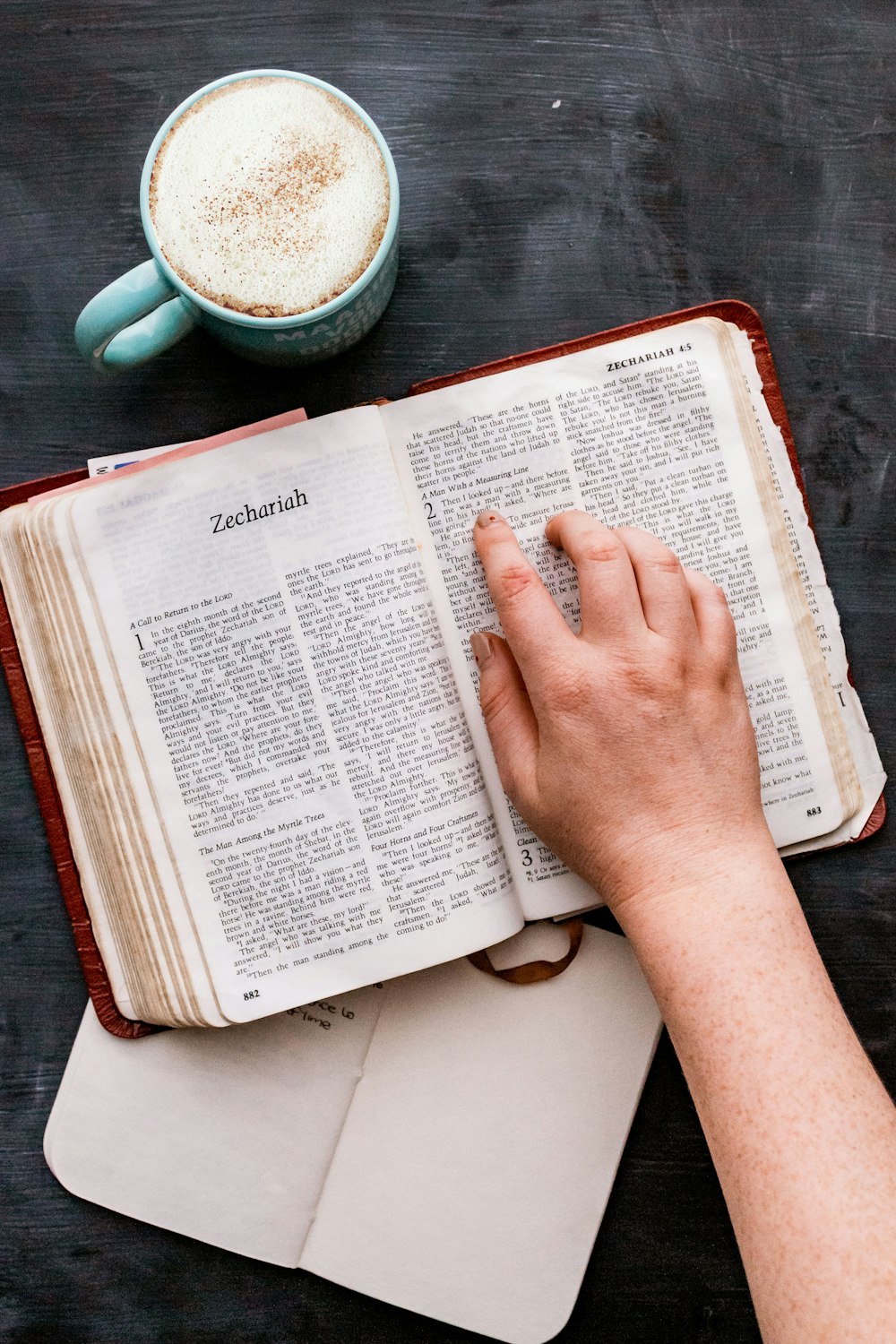 person holding white book page