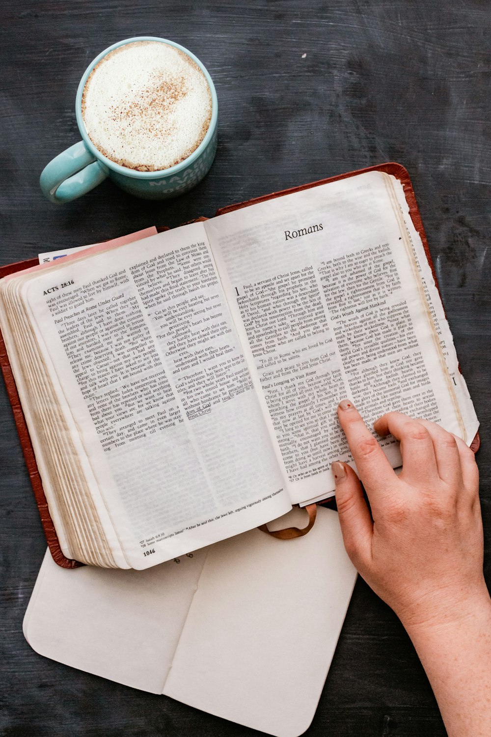 person holding white book page