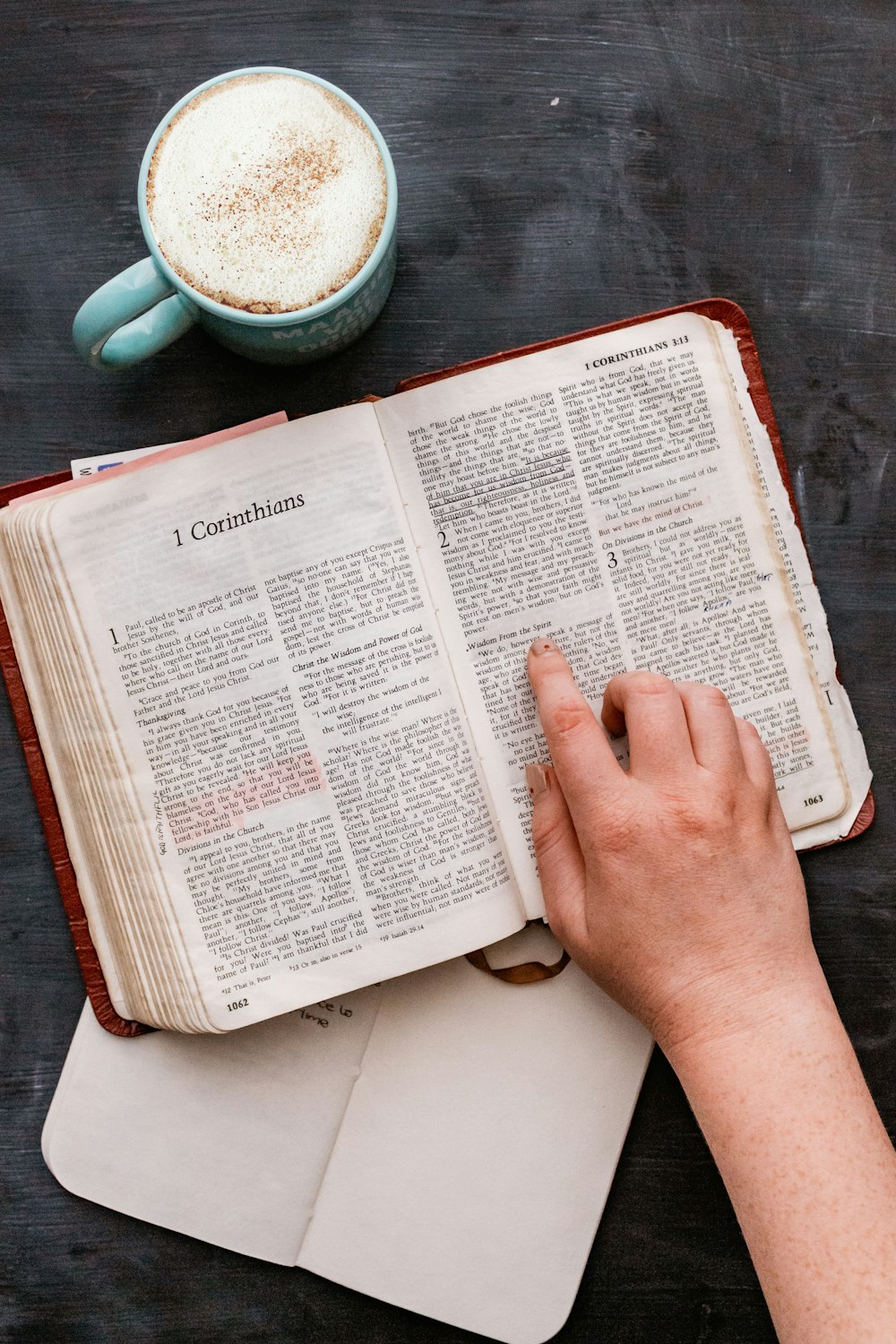 person holding white book page