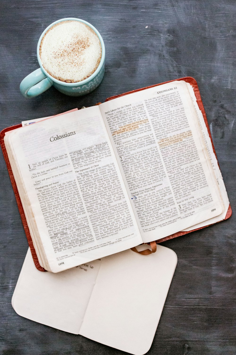 person holding white book page