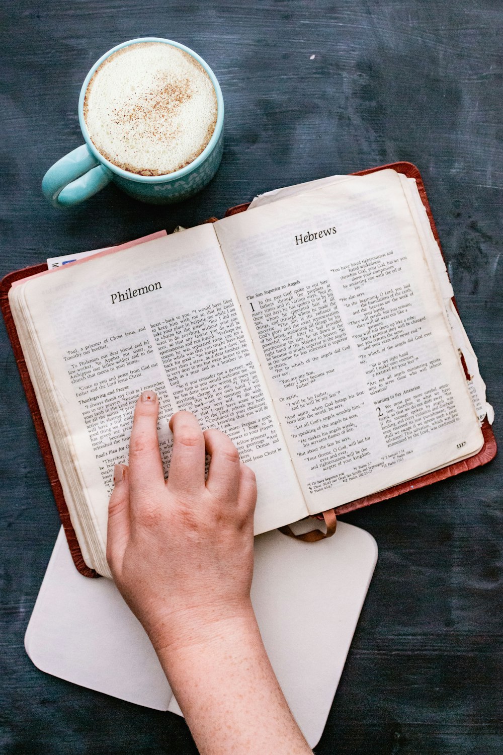 person holding white book page