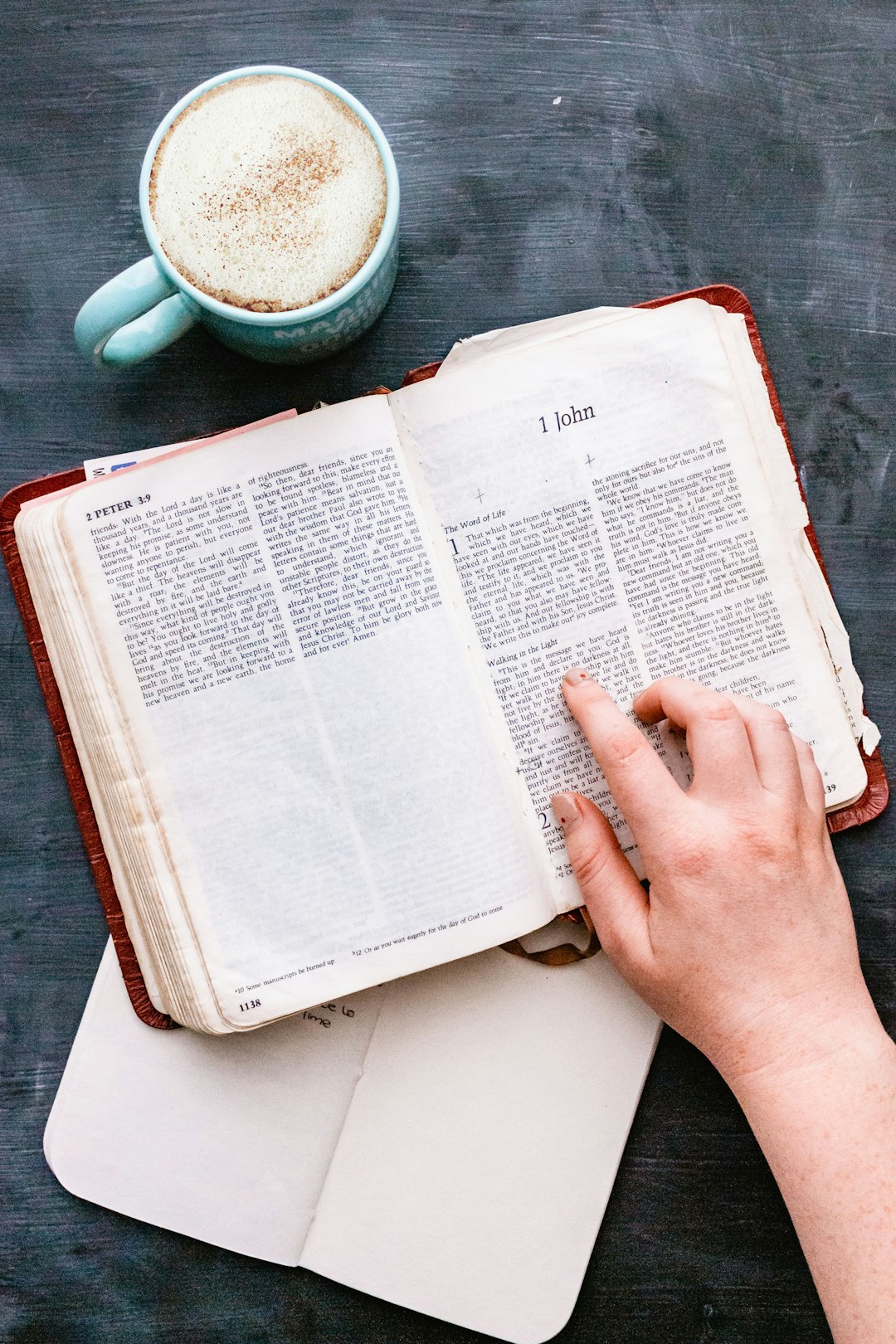 person holding white book page