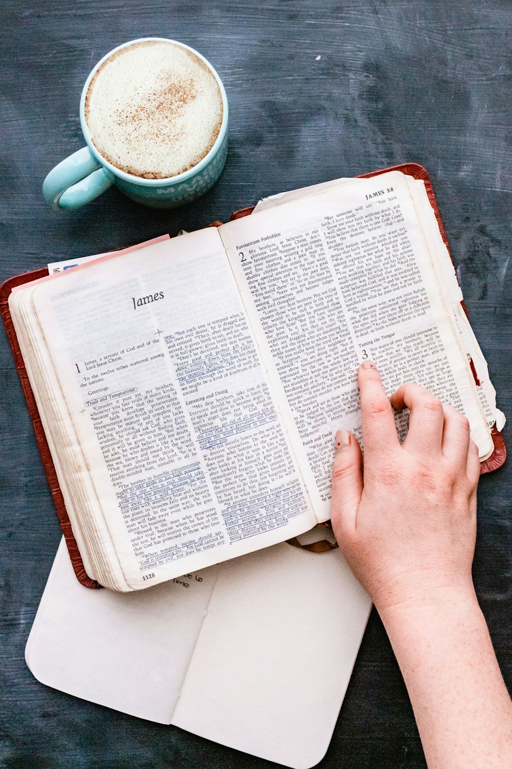 person holding white book page