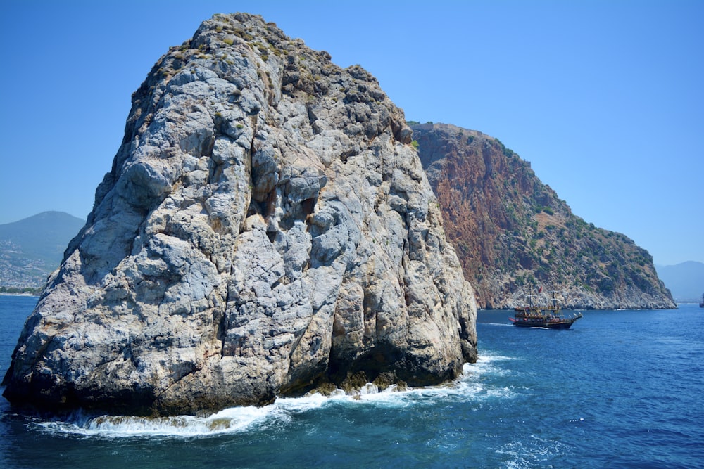 gray rock formation on sea during daytime