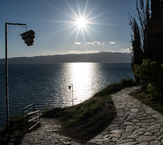 black and white basketball hoop near body of water during daytime in Ohrid North Macedonia