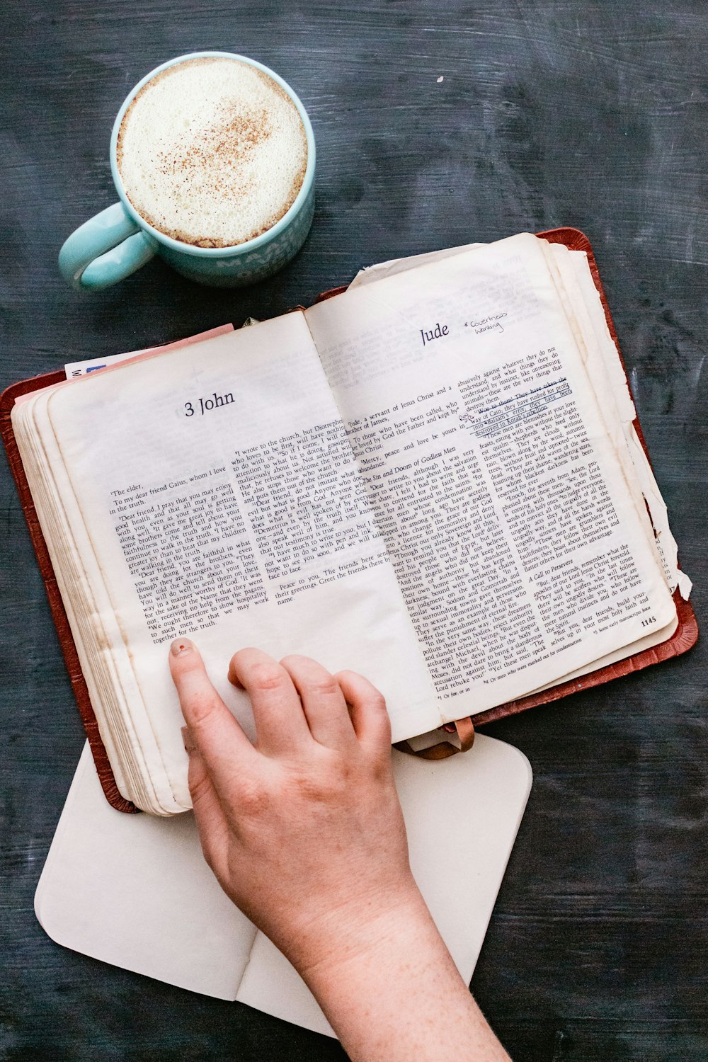 person holding white book page