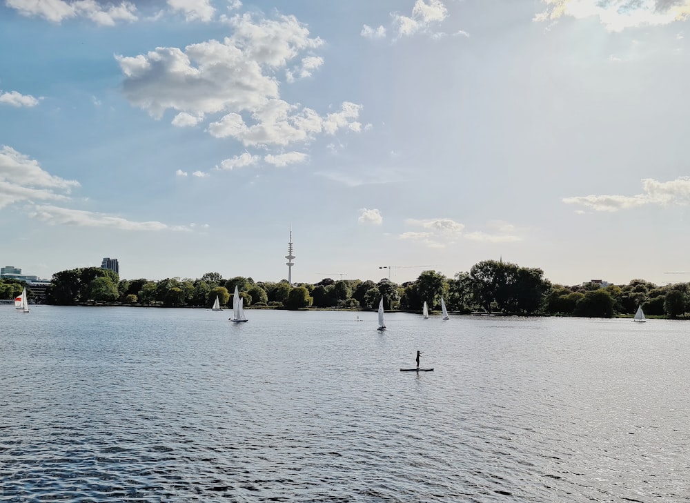 people on lake during daytime