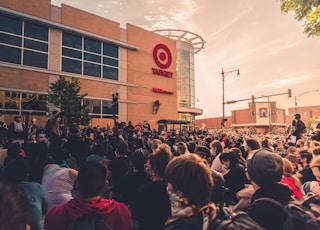 people gathering in front of brown building during daytime