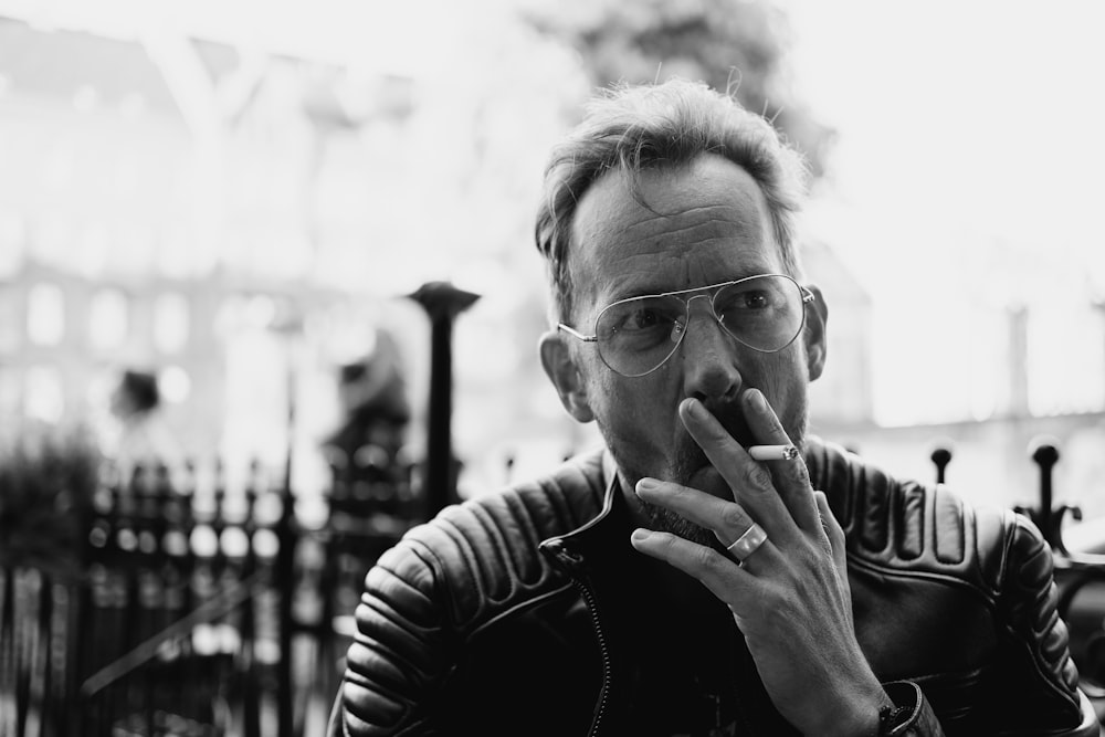 man in black and white striped long sleeve shirt wearing eyeglasses