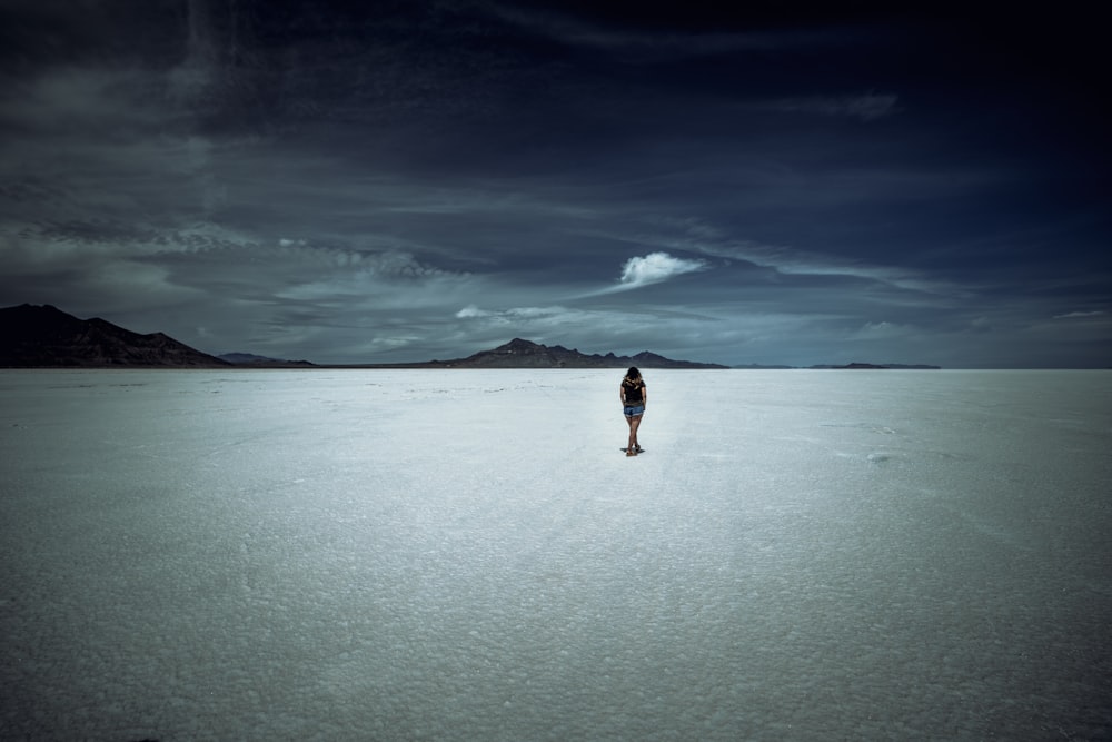 a person standing in the middle of a desert