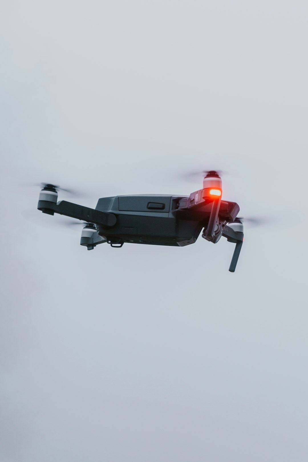 black and red drone in mid air