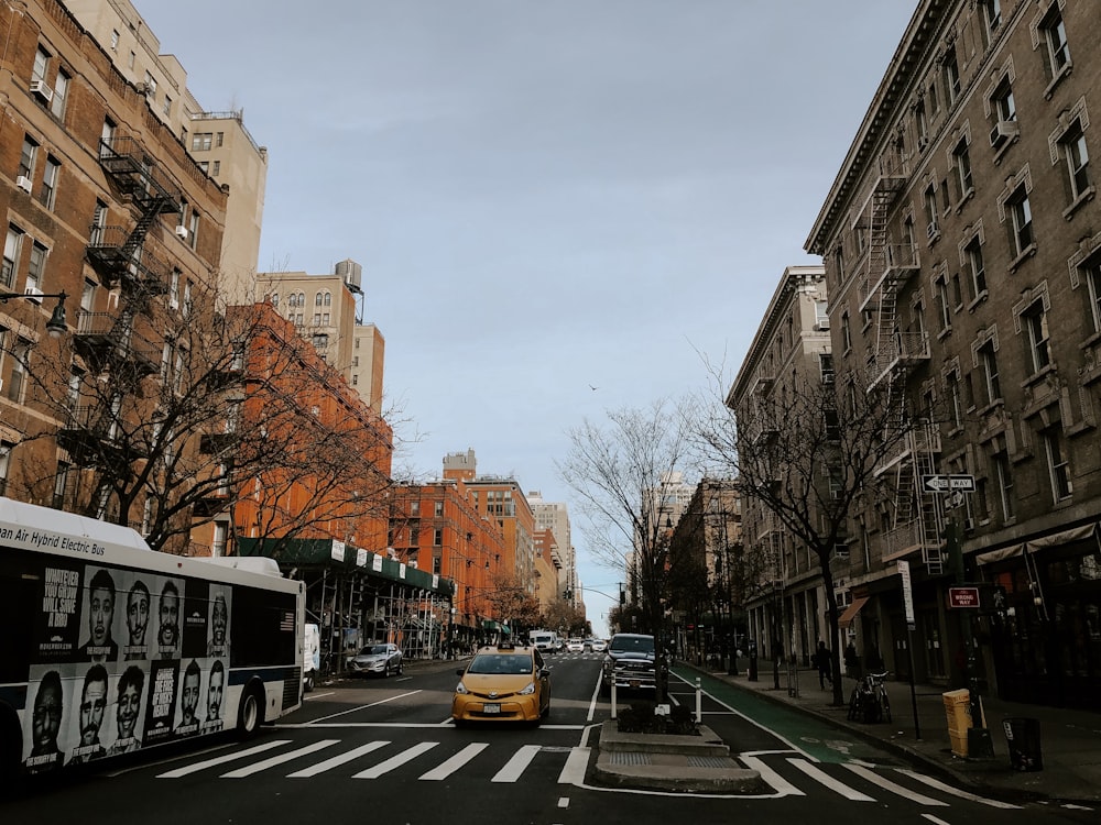 cars parked on side of the road near buildings during daytime