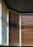 Vertical blinds partially open, allowing light to filter through, creating a pattern of light and shadow on the wooden slats. A mix of warm and cool tones is visible, with contrasting shades on each side influenced by the angle of the light.
