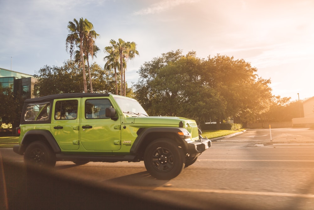 green crew cab pickup truck on road during daytime