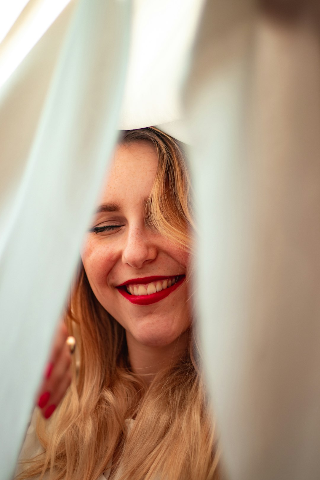 smiling girl in red and white shirt