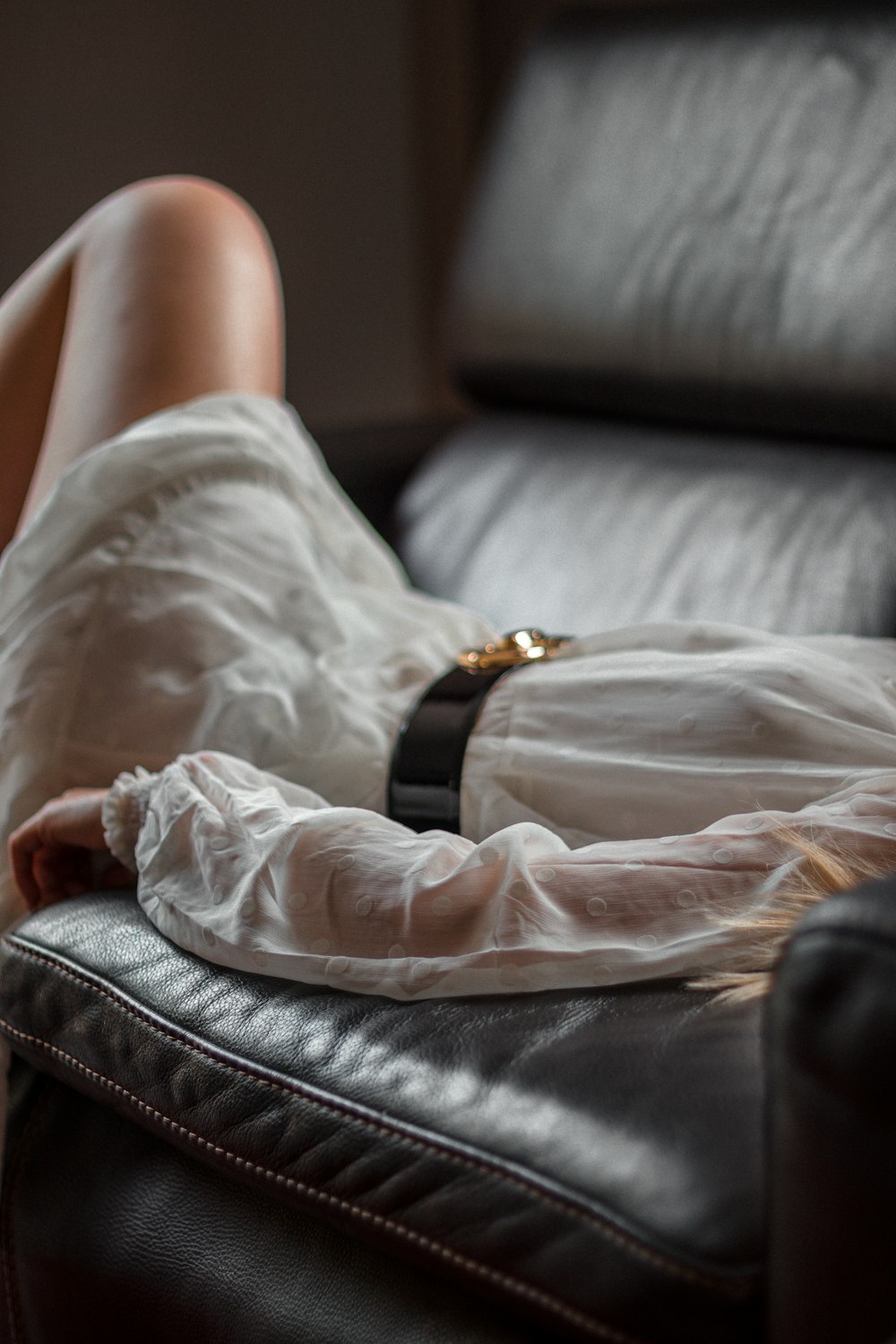 person in white shirt lying on bed