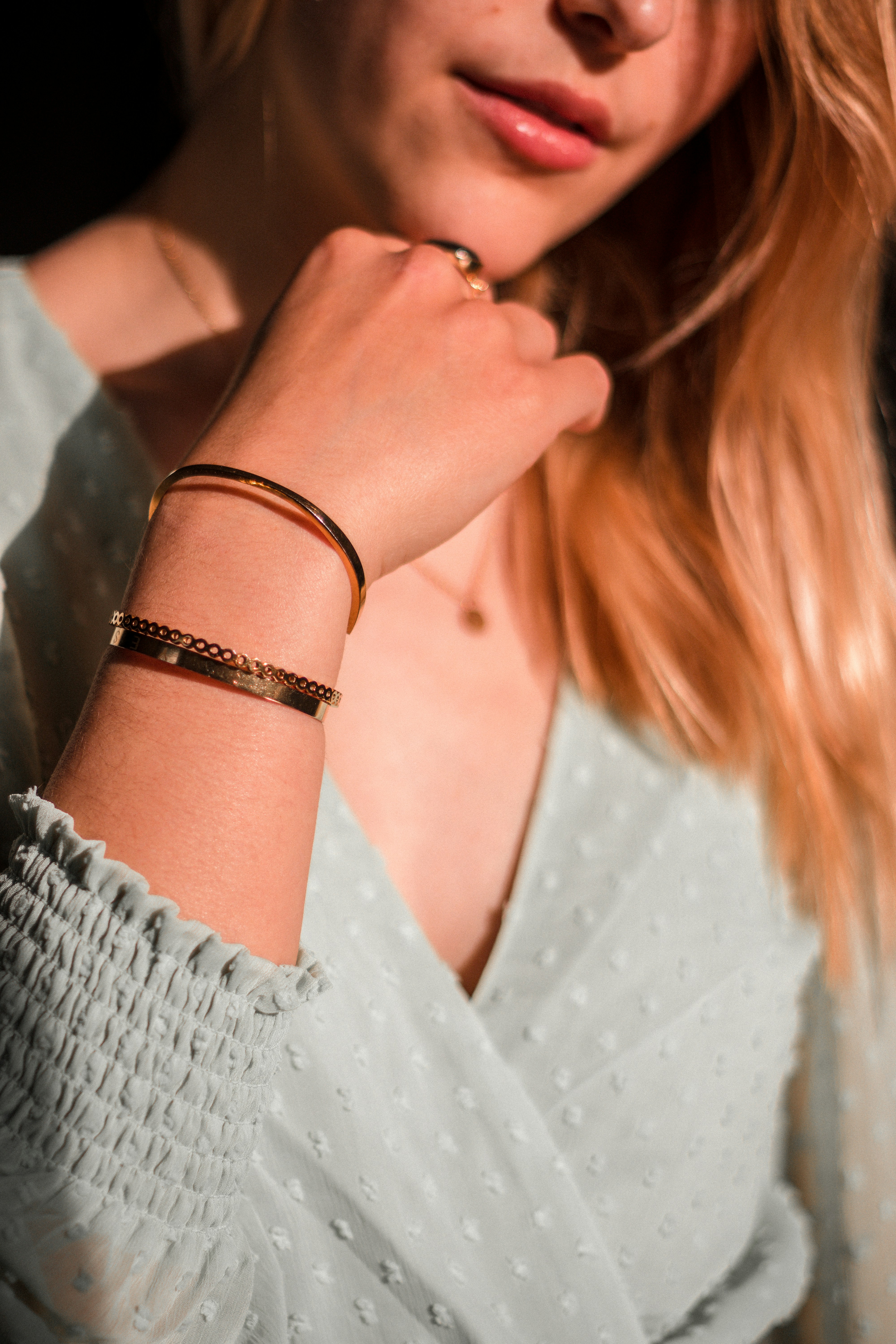 woman in white lace dress wearing silver bracelet