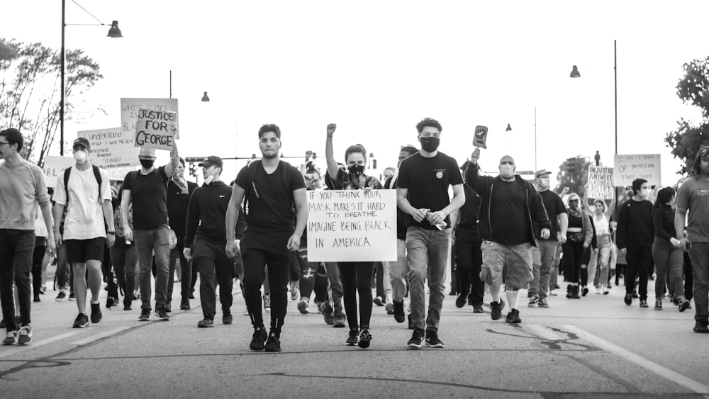 grayscale photo of people holding white printer paper