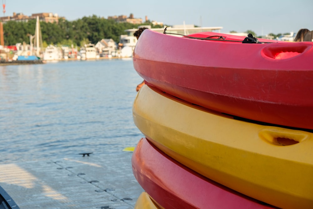 yellow and red kayak on sea shore during daytime