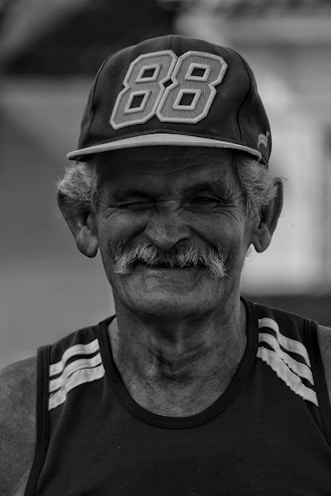 man in black and white crew neck shirt wearing black and white cap