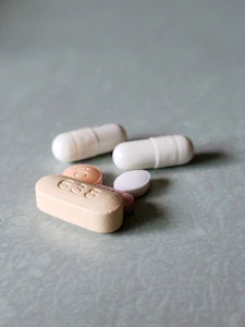 white medication pill on gray textile