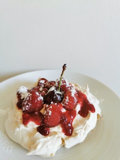 A plated dessert with fresh berries and a drizzle of sauce