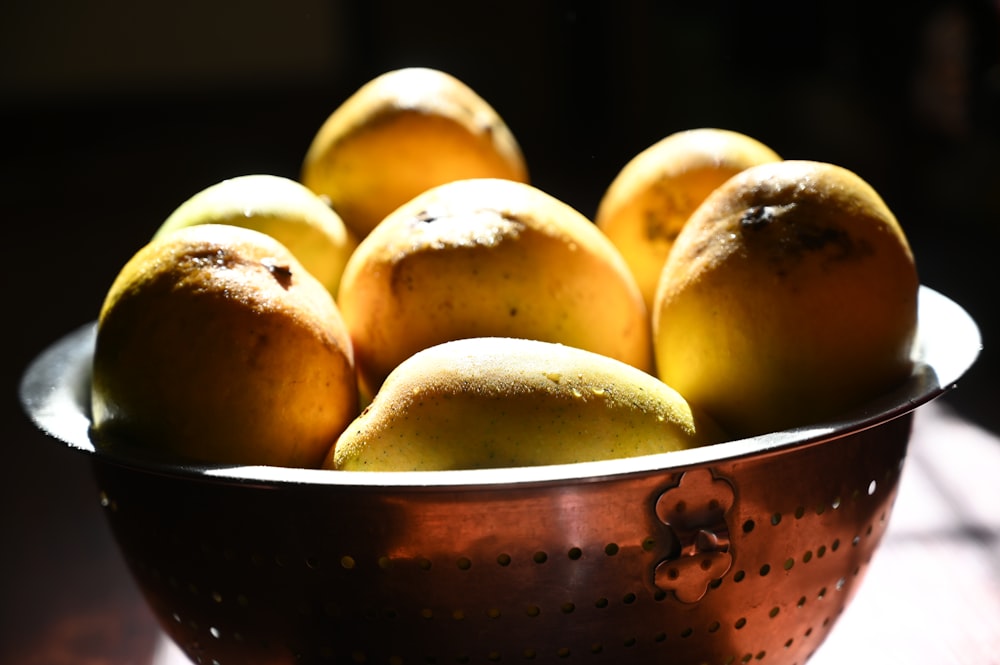 yellow round fruits on white ceramic bowl