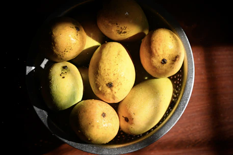 Close-up of ripe mangoes undergoing hot water treatment in a modern facility.