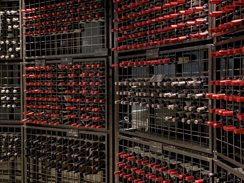 red and black coca cola bottles on black metal shelf